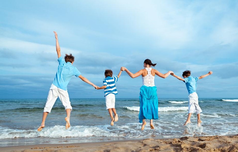 full family enjoying in the beach