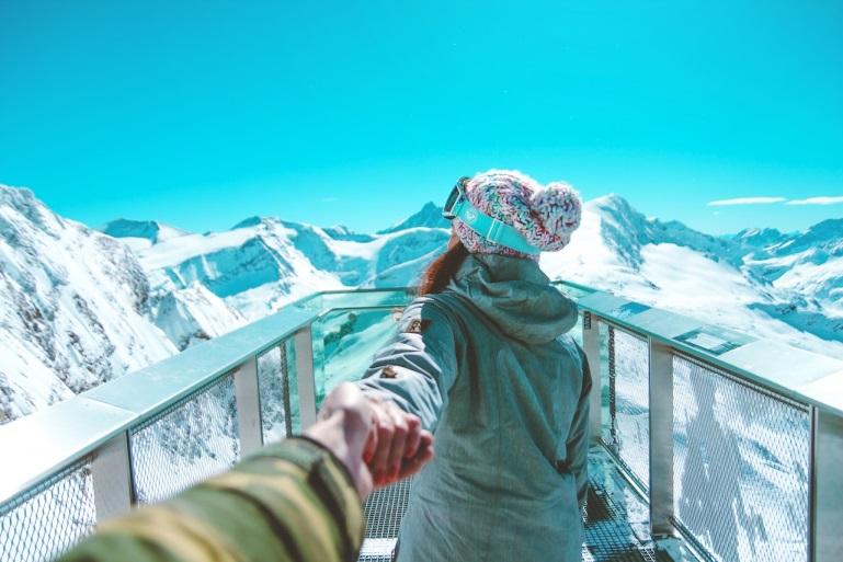 a couple on a terrace overlooking the mountains