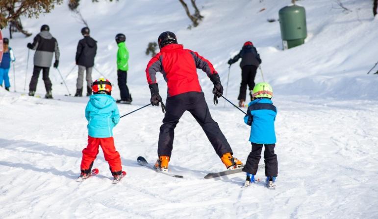 adults and children skiing