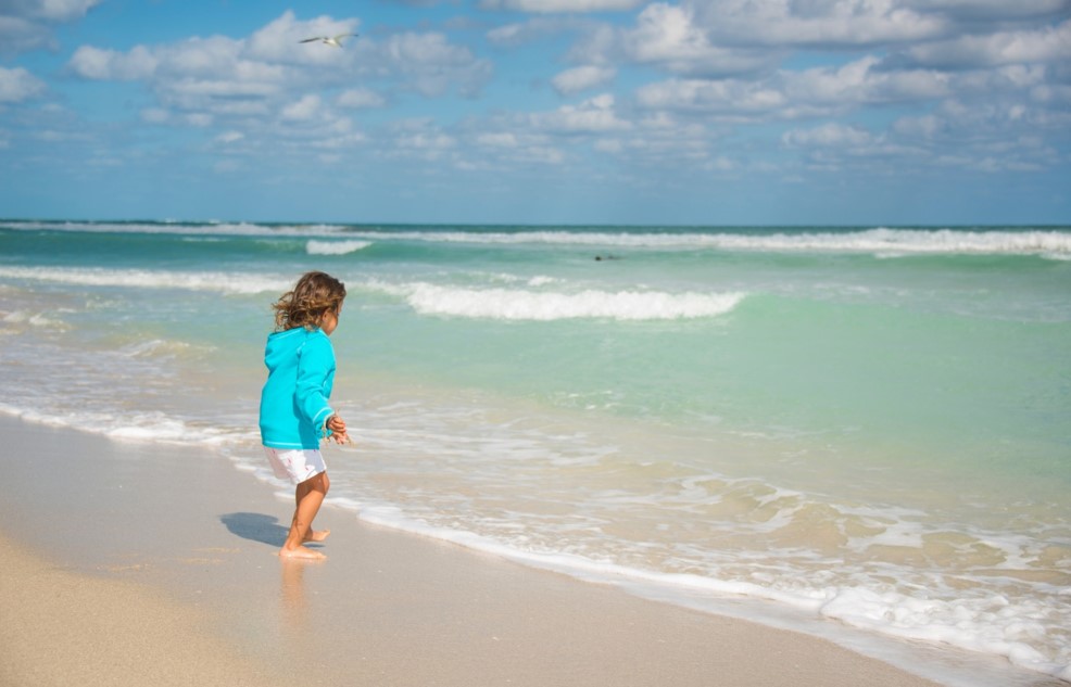 child running into the sea