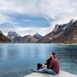 couple sitting on a wooden dock