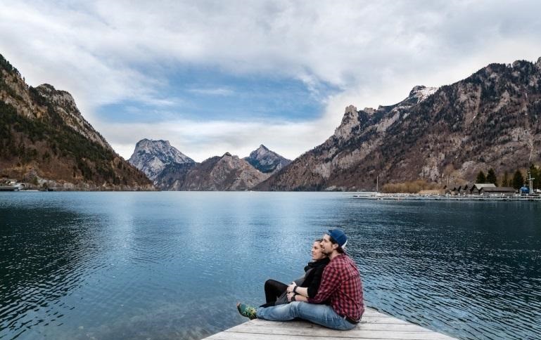 couple sitting on a wooden dock