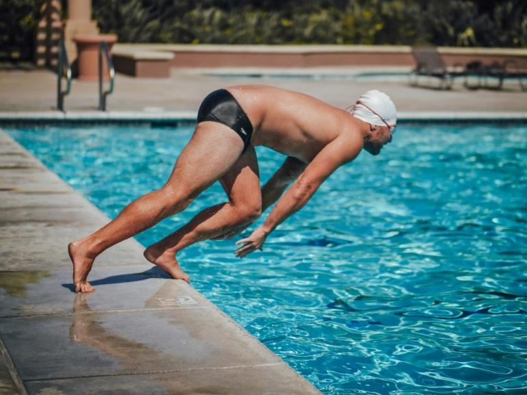 man diving into a pool