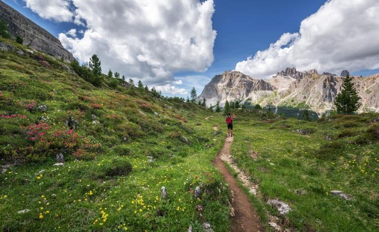 man hiking up a hill