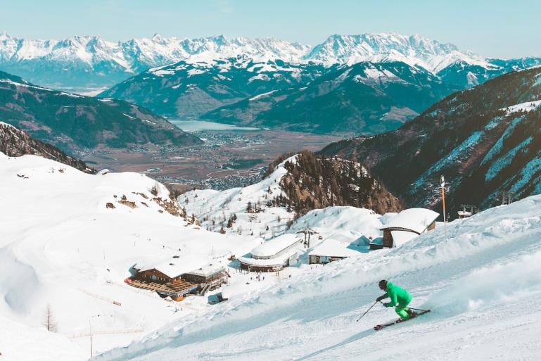 man skiing down a mountain slope