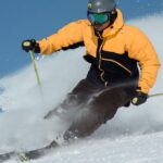 man skiing with a yellow jacket