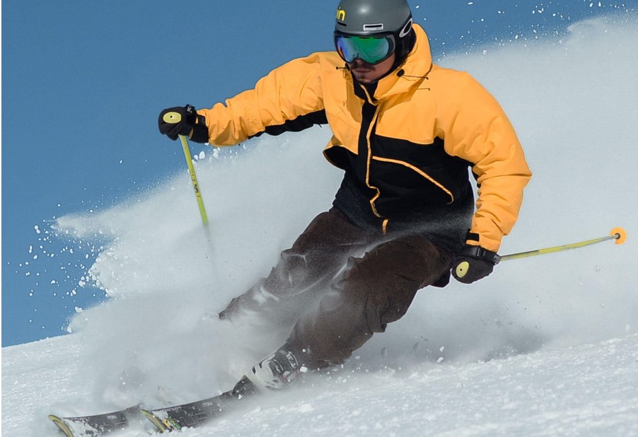 man skiing with a yellow jacket