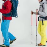 people wearing ski wear with ski poles