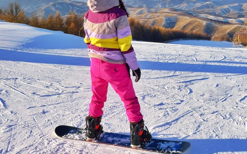 person standing on a snowboard