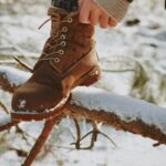 woman wearing winter boots in a forest