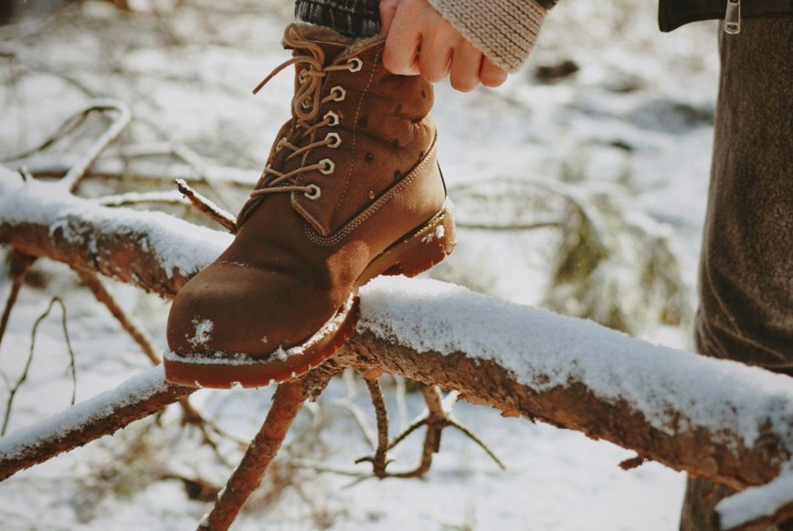 woman wearing winter boots in a forest